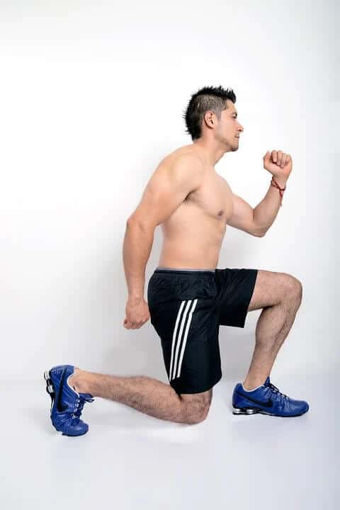 A man performing lunges to strengthen his knees.