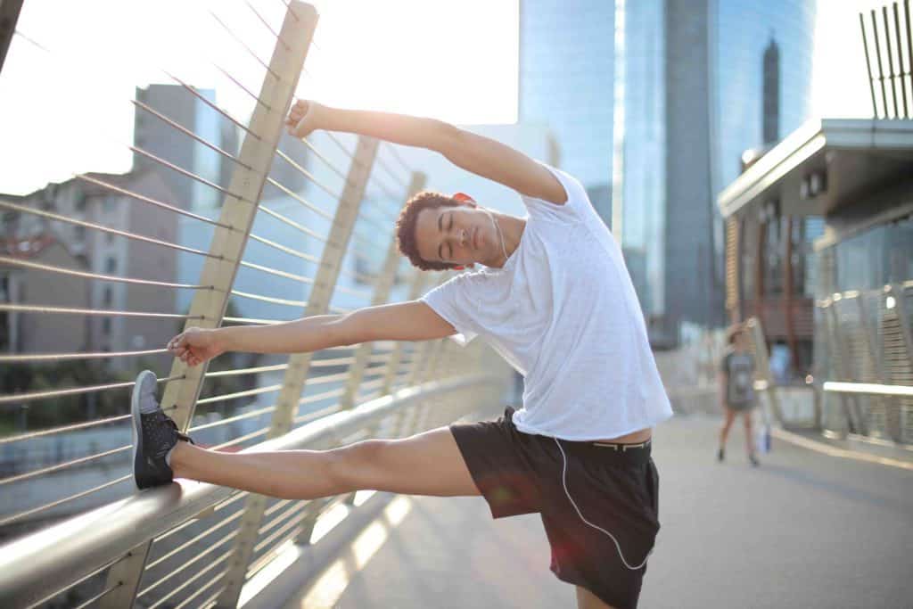 Cycling-Related Lower Back Pain - A man doing stretch before riding his bicycle