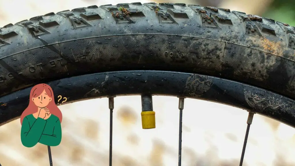 Photo of a yellow tire valve cap and the tire itself.