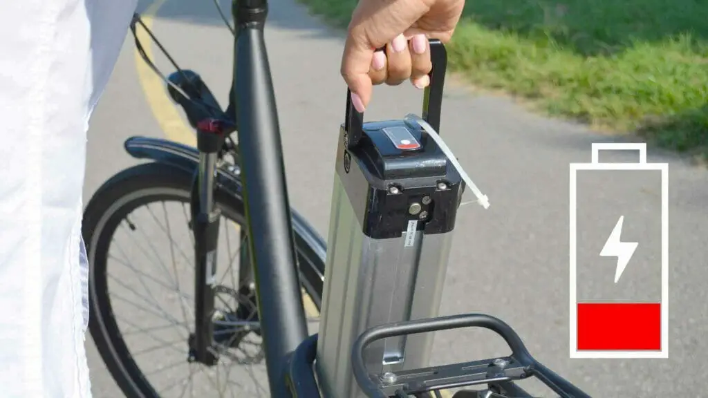 Photo of an electric bike battery being removed because is fully dischatged.