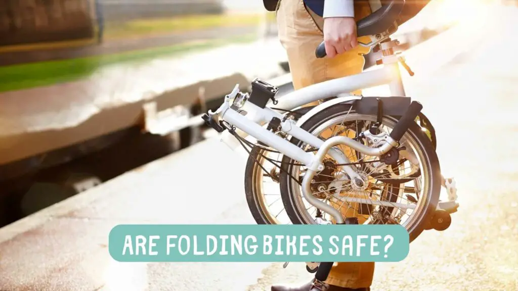 Photo of a person carrying a folded bicycle. Are Folding Bikes Safe?