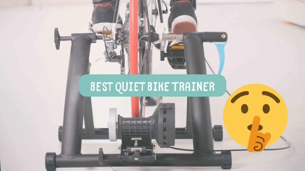 Photo of a bike trainer with a bike in it and a person pedaling and a yellow emoji with a finger in front of its mouth making shsh.