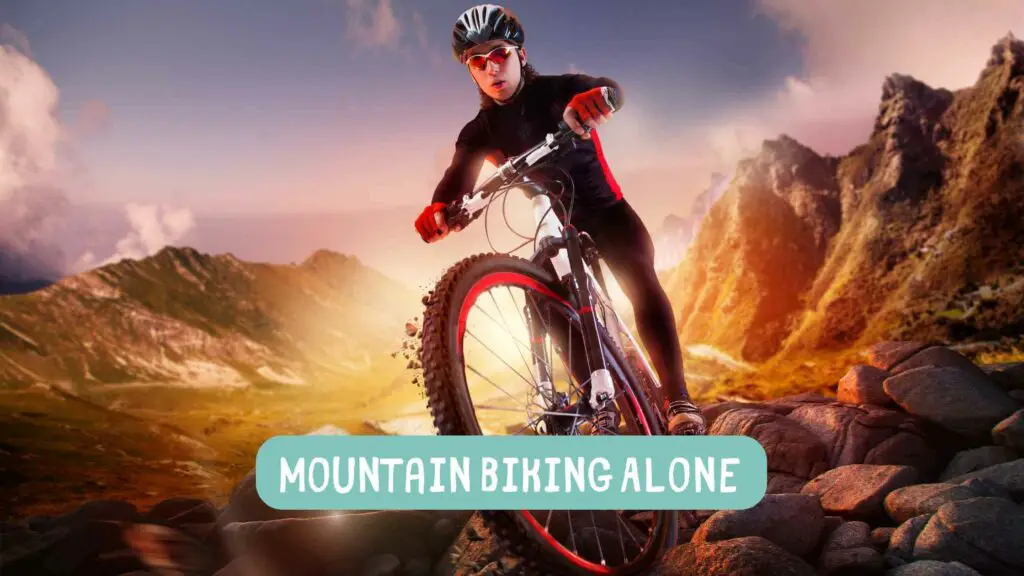 Photo of a man with black clothes with a red stripe and gloves mountain biking alone.