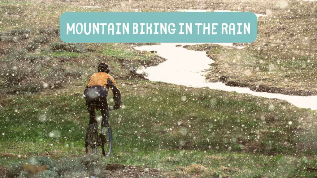 Photo of a person mountain biking in the rain.