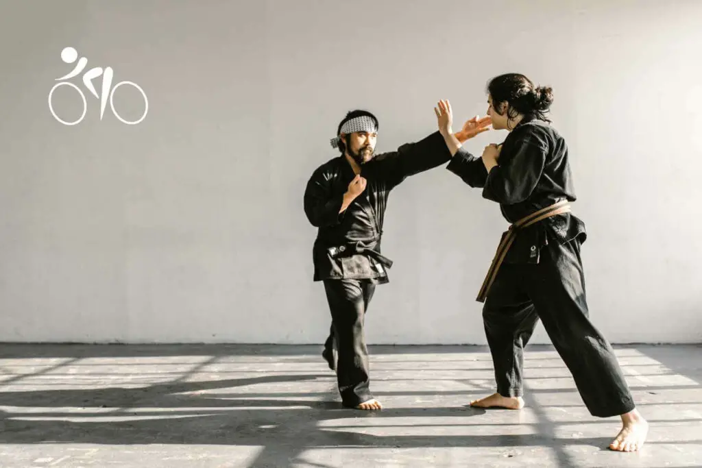 Photo of two men practicing Taekwondo with black kimonos.